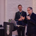 A speaker at a podium addressing the audience at a startup event